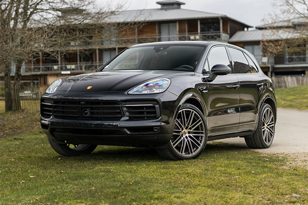 Black Porsche Cayenne parked on grass